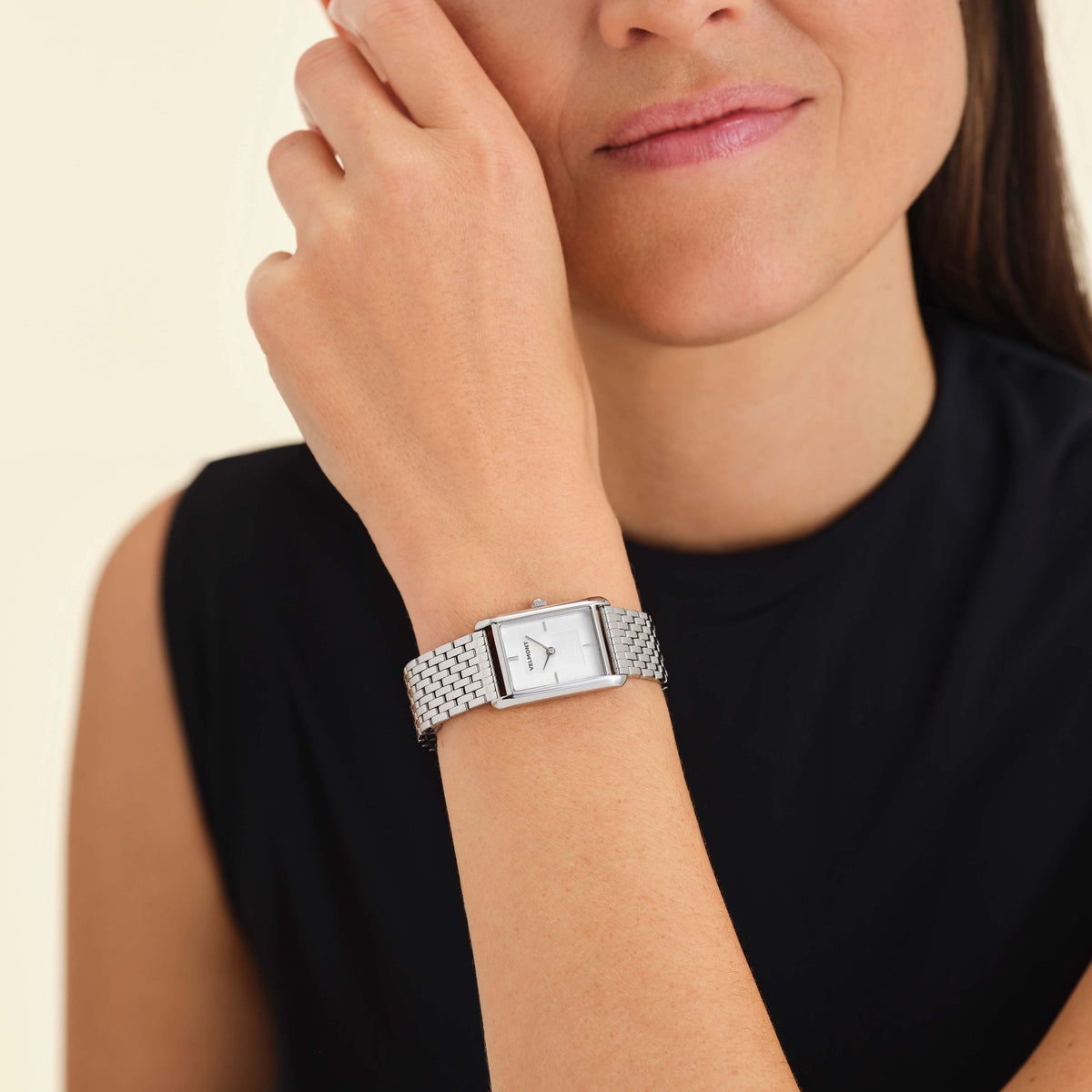 Rectangular watch worn near the face