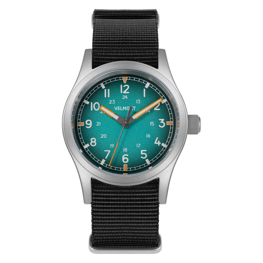 Teal blue dial field watch on a black nylon strap