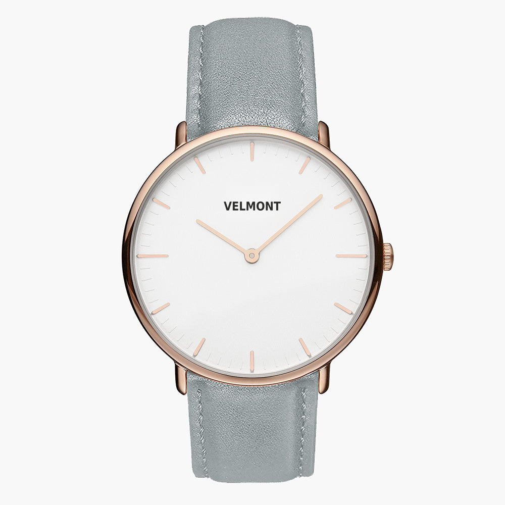 Watch with a white dial and rose gold-tone case on a dove gray strap, shown from the front.
