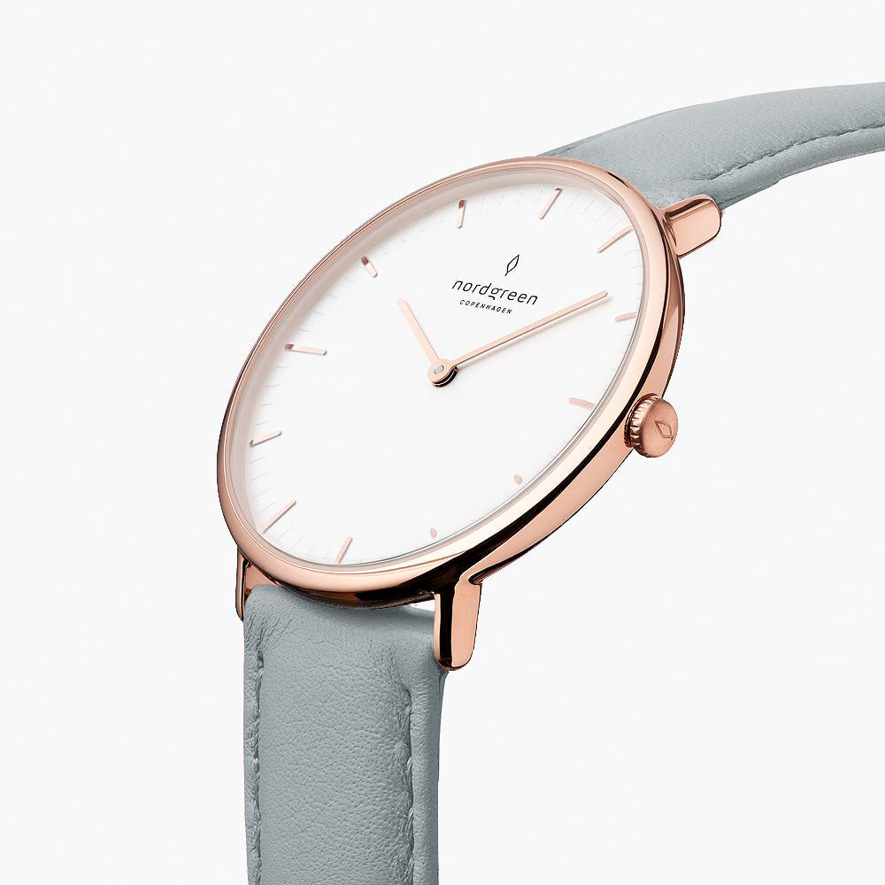 Three-quarter view of the watch showing the white dial and dove gray strap.