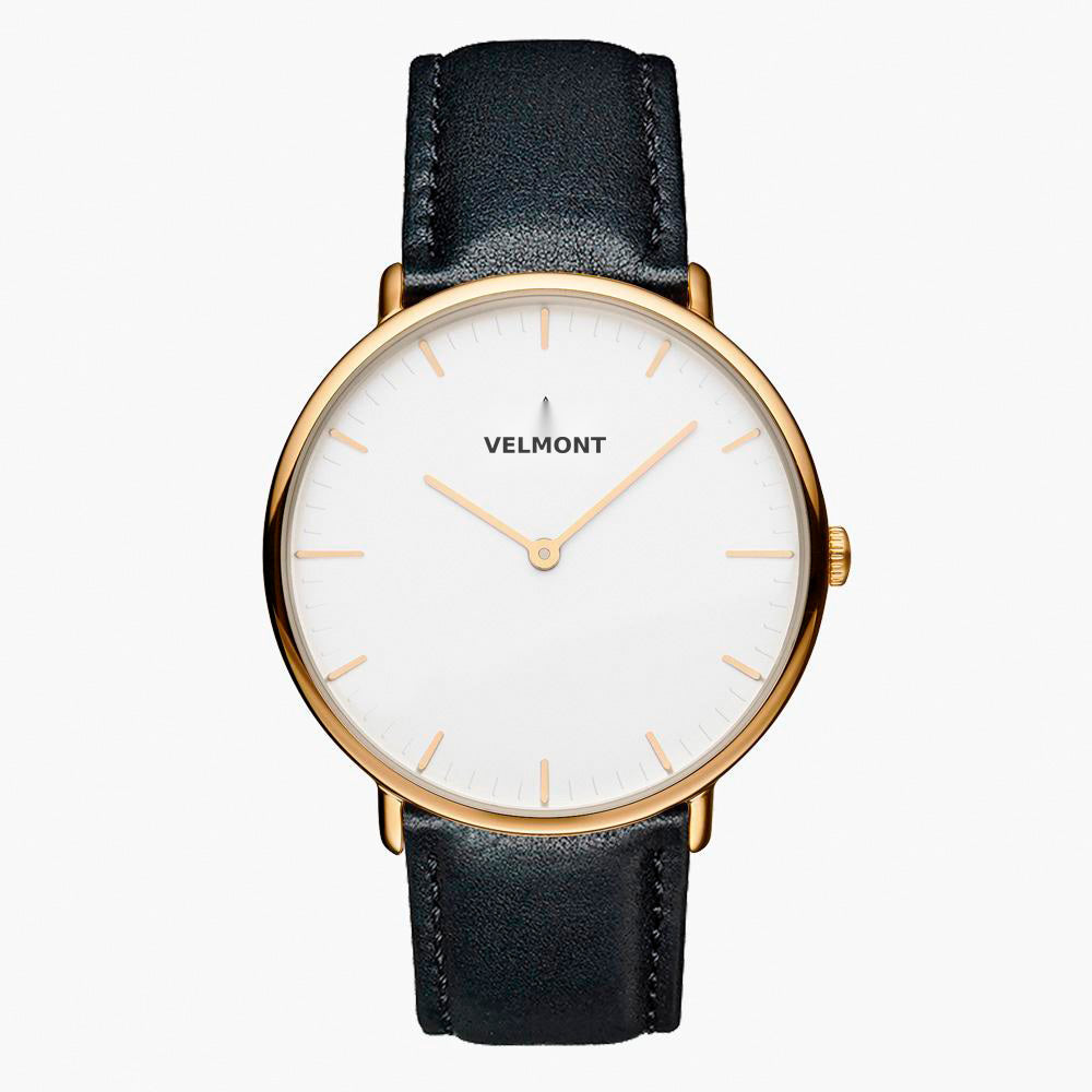 Minimalist watch with a white dial and gold-tone case on a black strap.