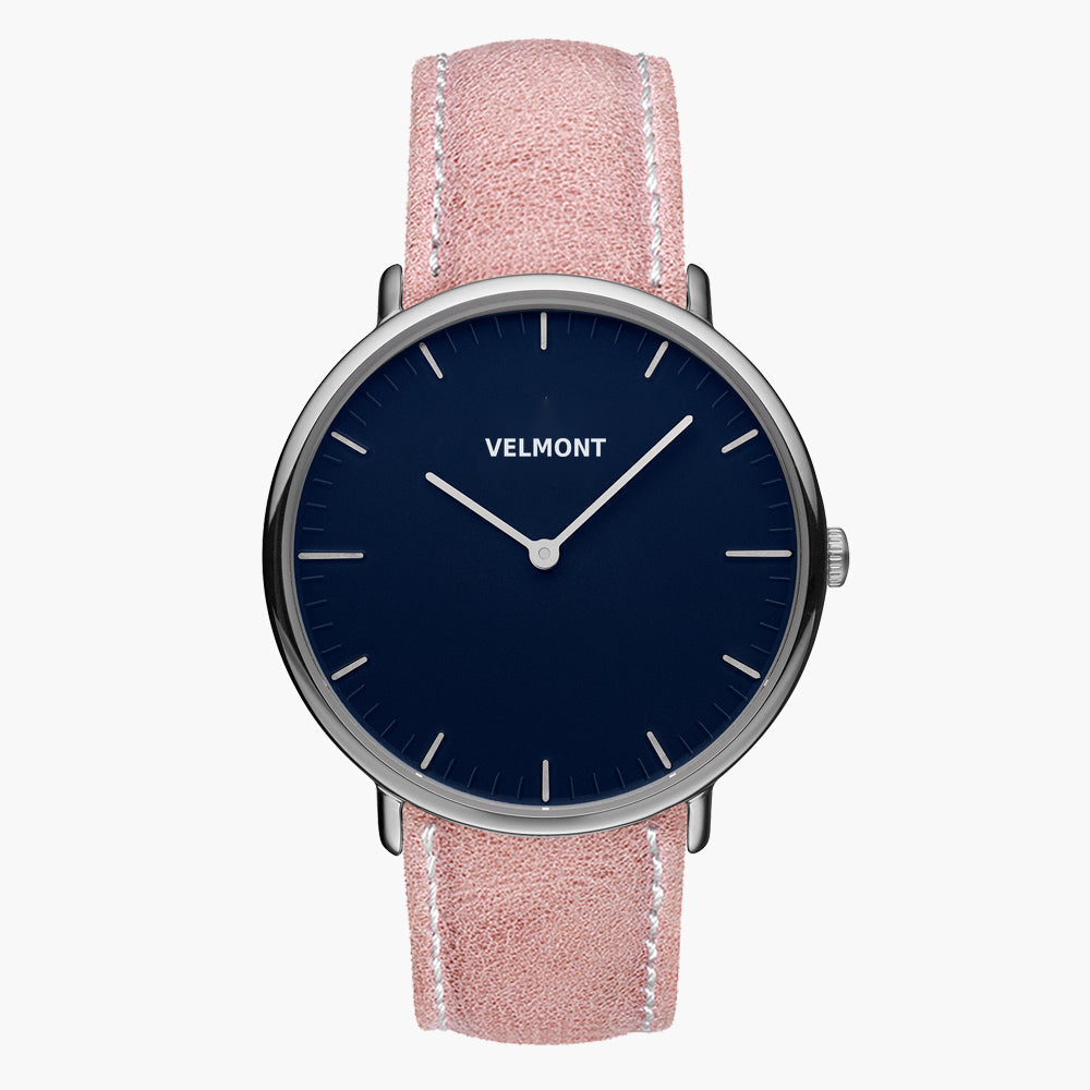 Watch with a navy blue dial and silver-tone case on a pink strap with white stitching.