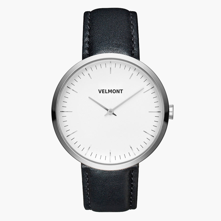 Minimalist watch with a white dial and silver-tone case on a black strap.