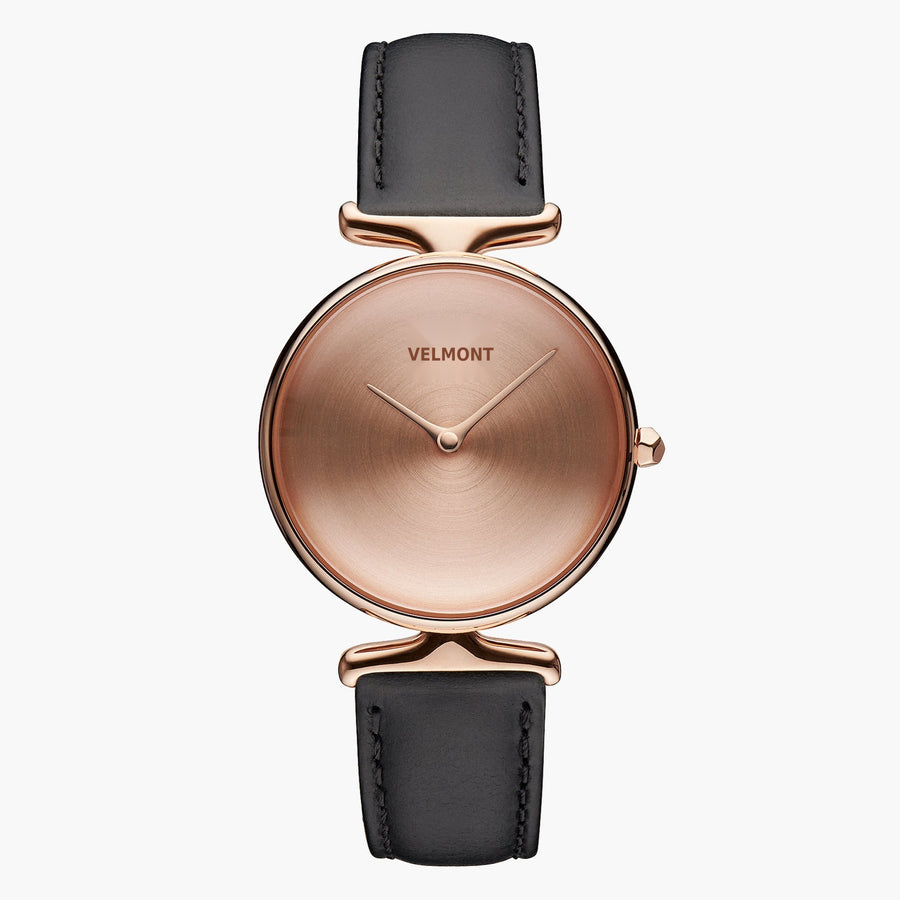 Watch with a rose gold-tone dial and case on a smooth black strap.