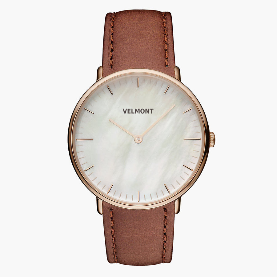 Pearlescent white dial with a rose gold-tone case on a smooth brown strap.