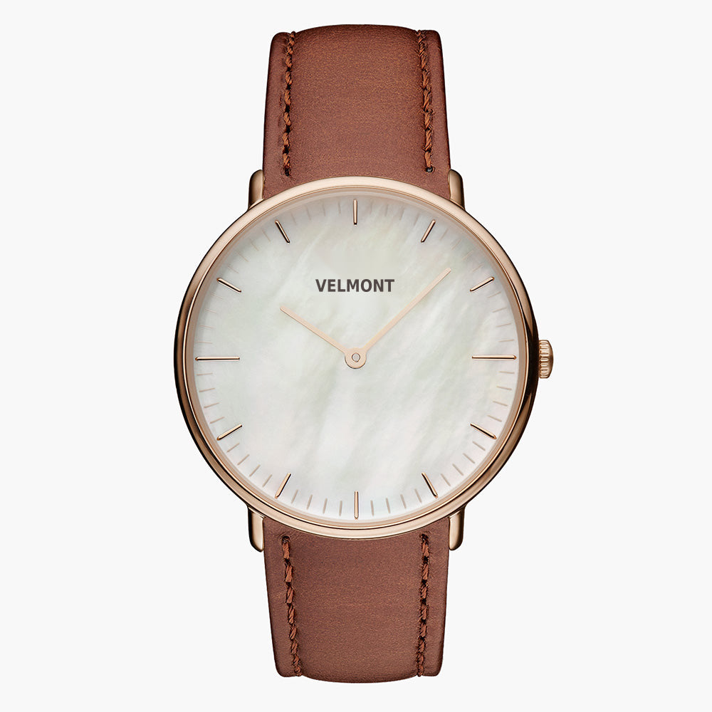 Pearlescent white dial with a rose gold-tone case on a smooth brown strap.
