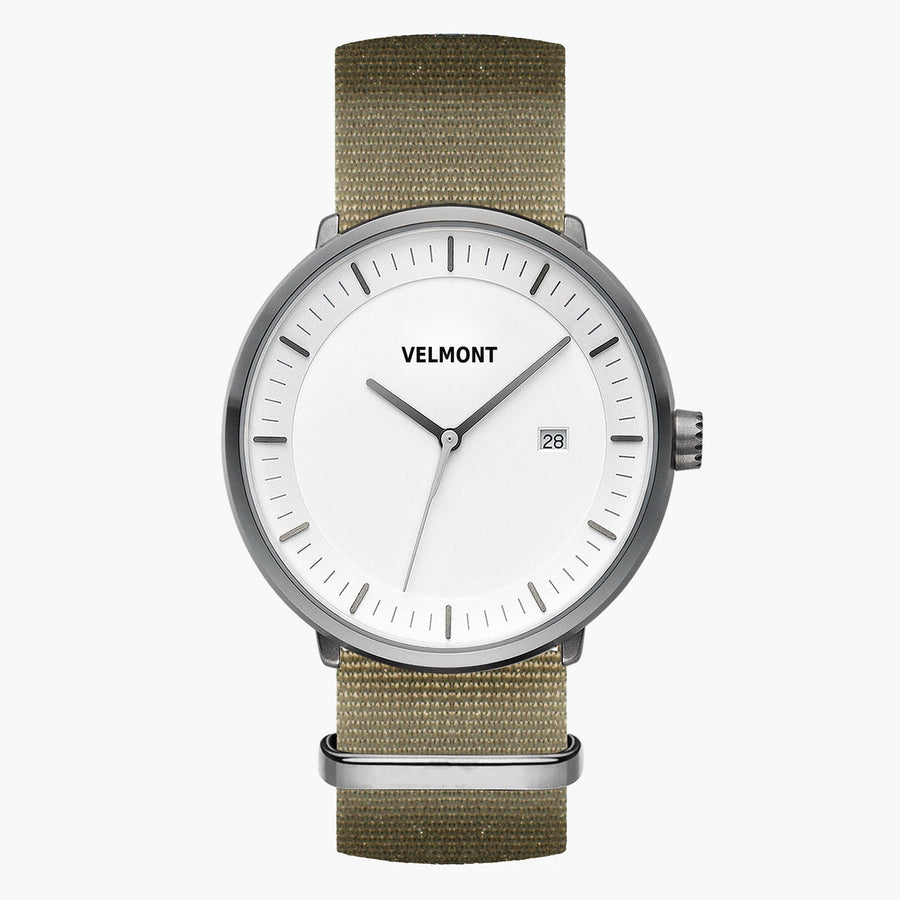 Watch with a white dial and gunmetal case on an olive green woven strap.