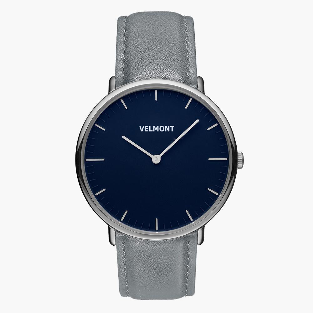 Watch with a navy blue dial and silver-tone case on a gray strap.