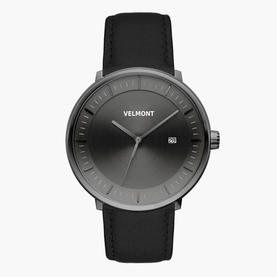Front view of a gunmetal watch with a gunmetal gray sunburst dial on a black strap.