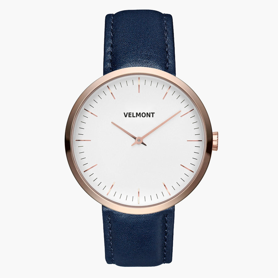 Watch with a white dial and rose gold-tone case on a navy blue strap, front view.
