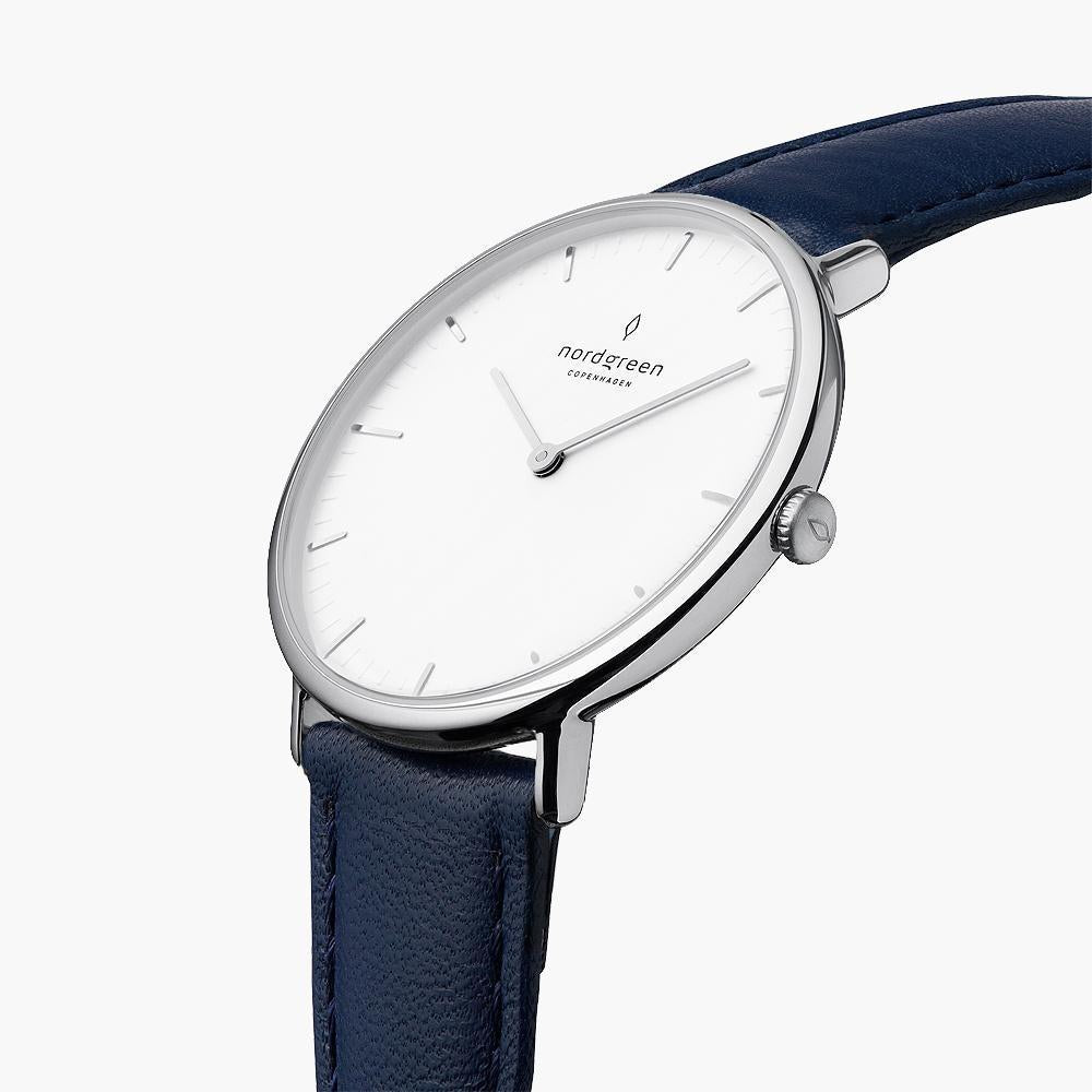 Three-quarter view of the slim silver-tone case on a navy strap.