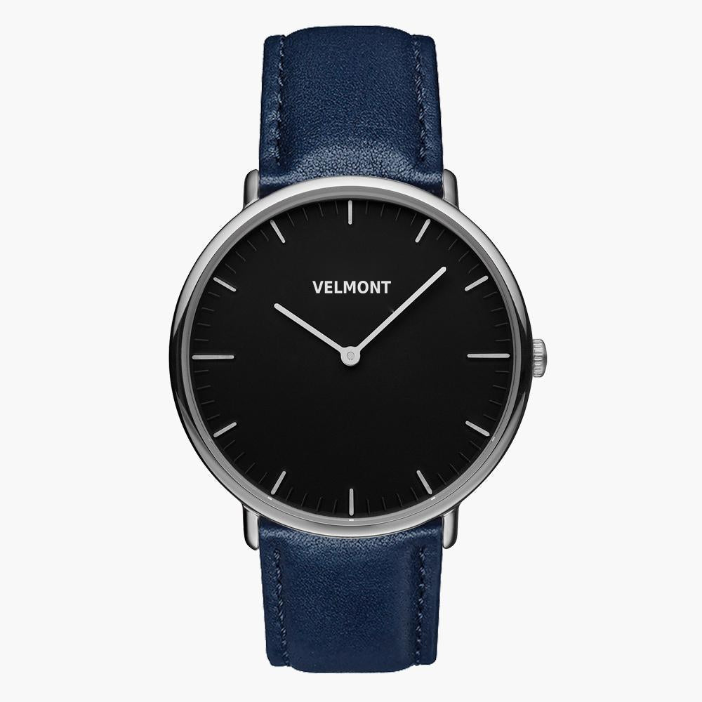 Watch with a black dial and silver-tone case on a navy strap, front view.