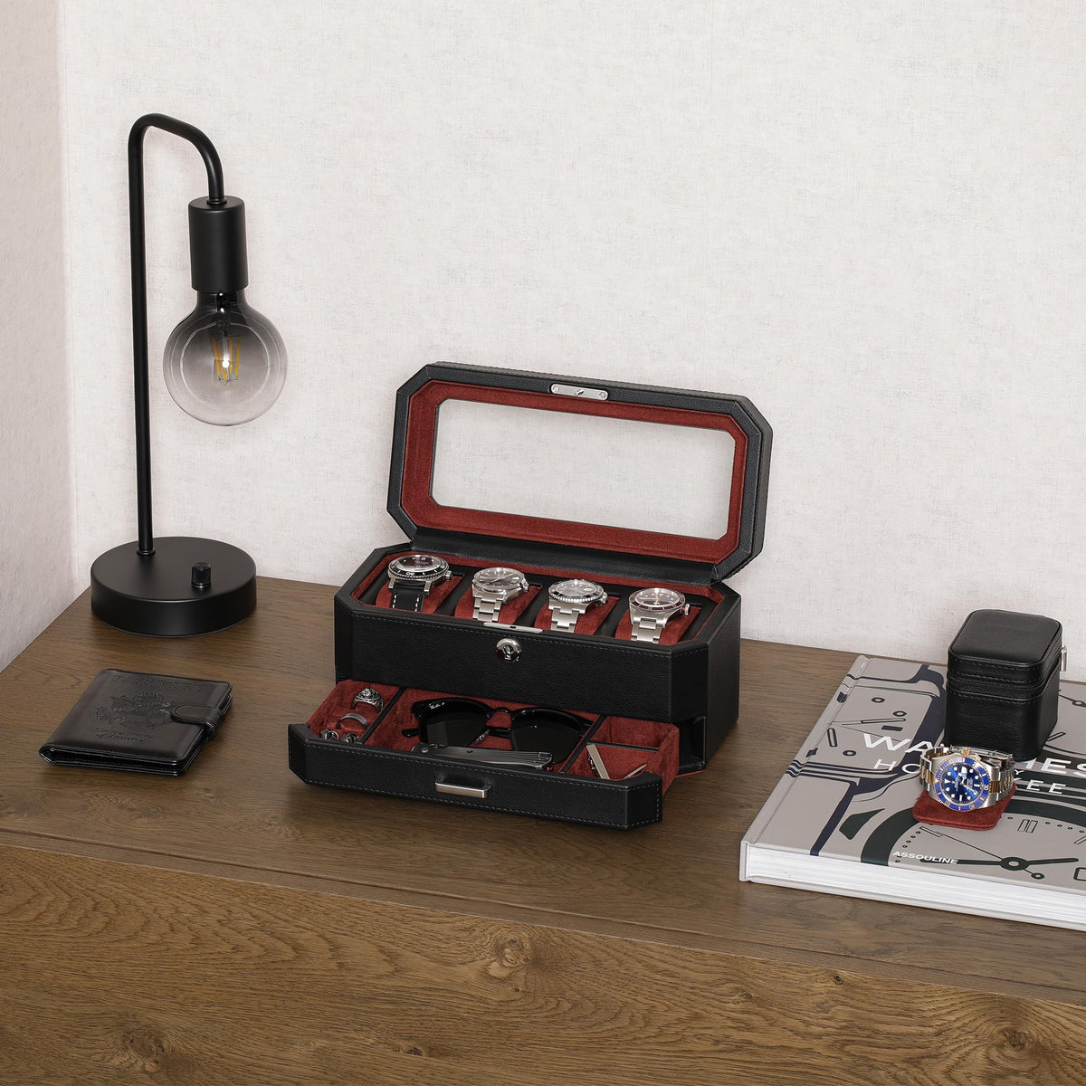 Open four-slot box with drawer pulled out on a wooden desk