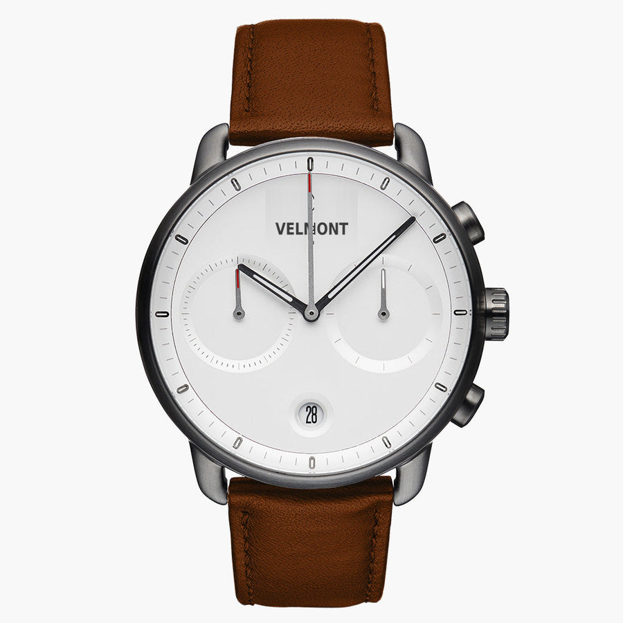 Chronograph-style watch with a white dial and gunmetal case on a brown strap.