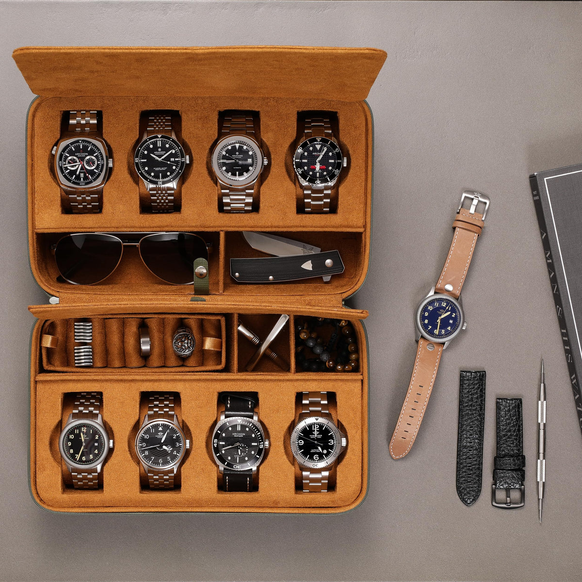 Top view of the open case filled with watches next to a spare strap