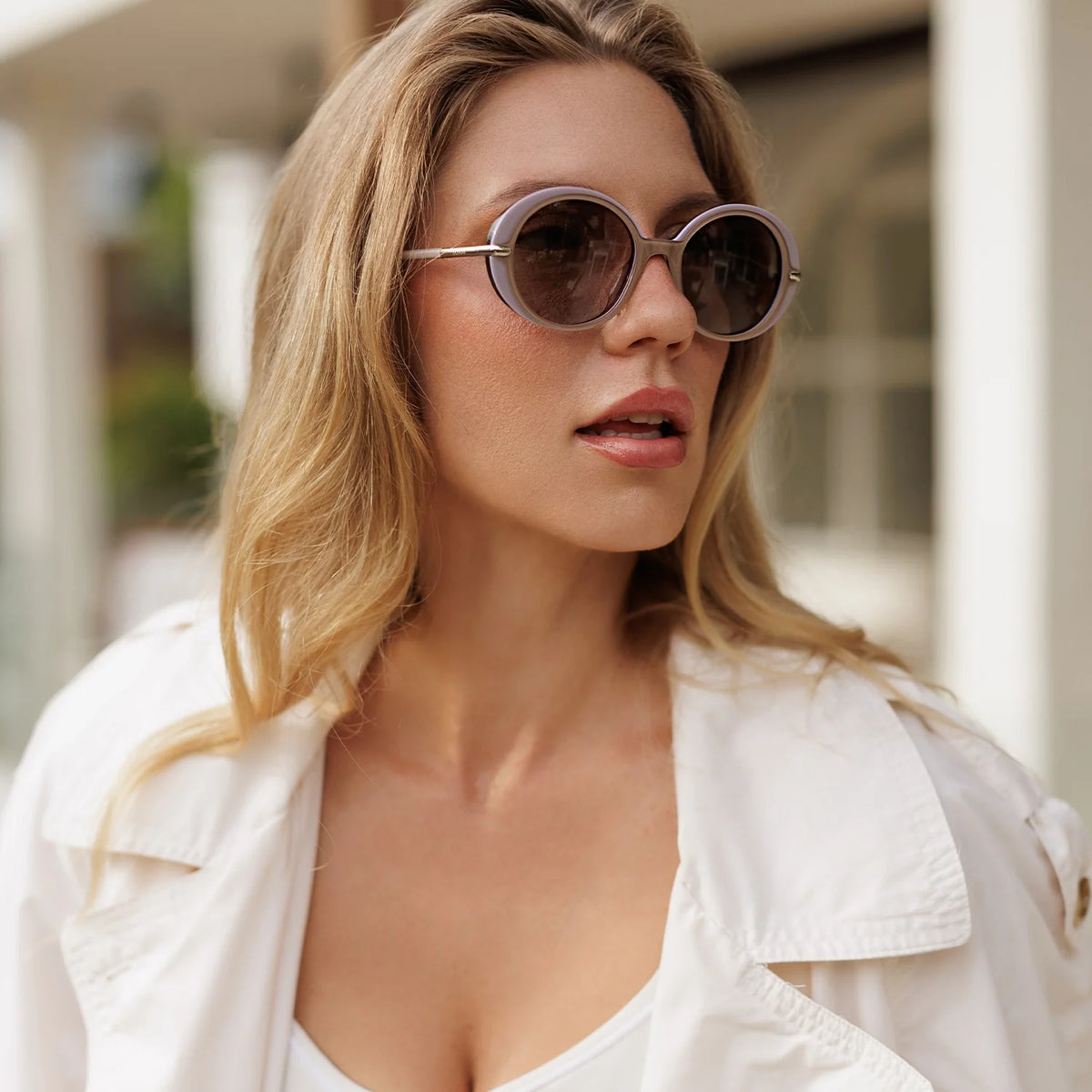 Woman in round sunglasses looking to the side