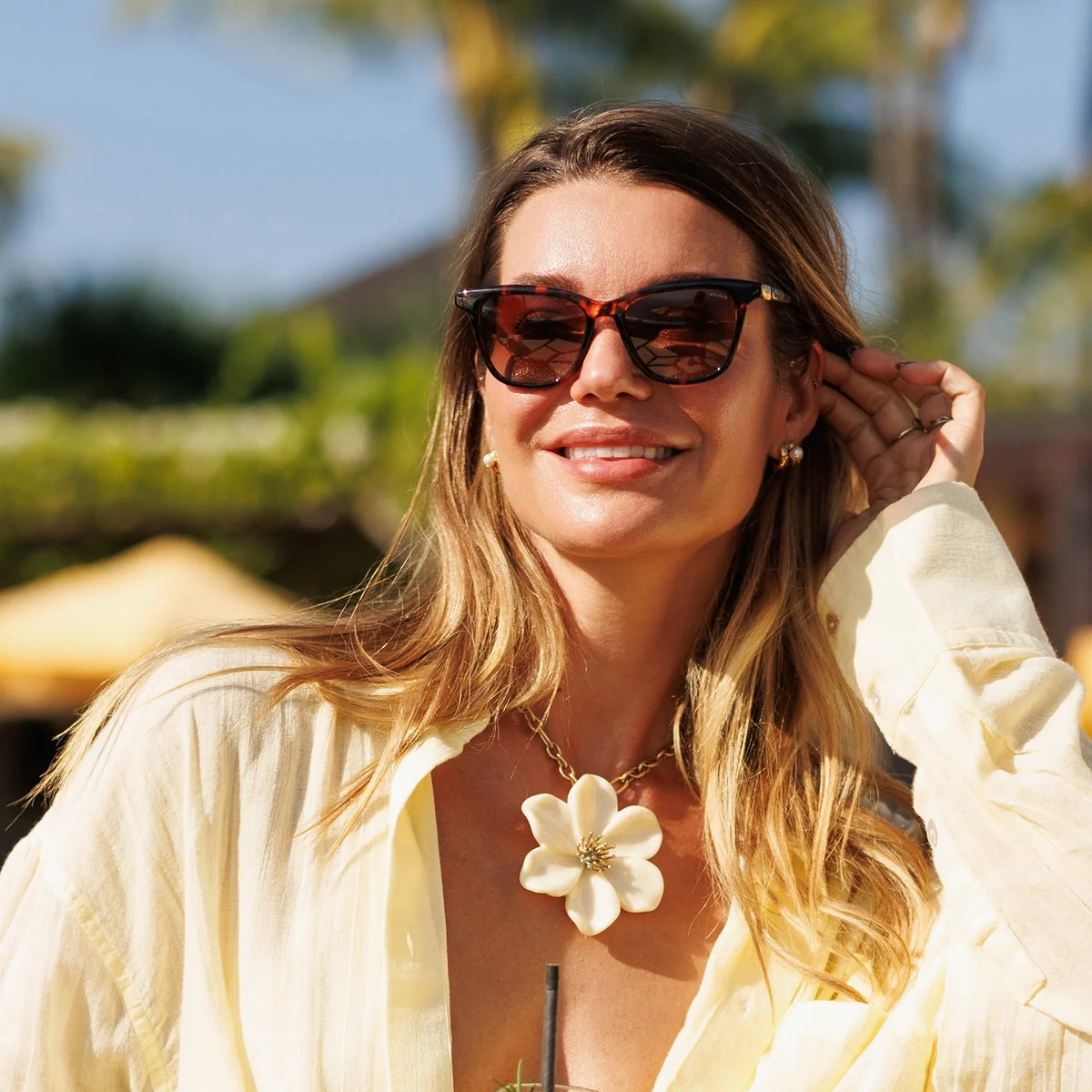 Woman adjusting cat eye sunglasses