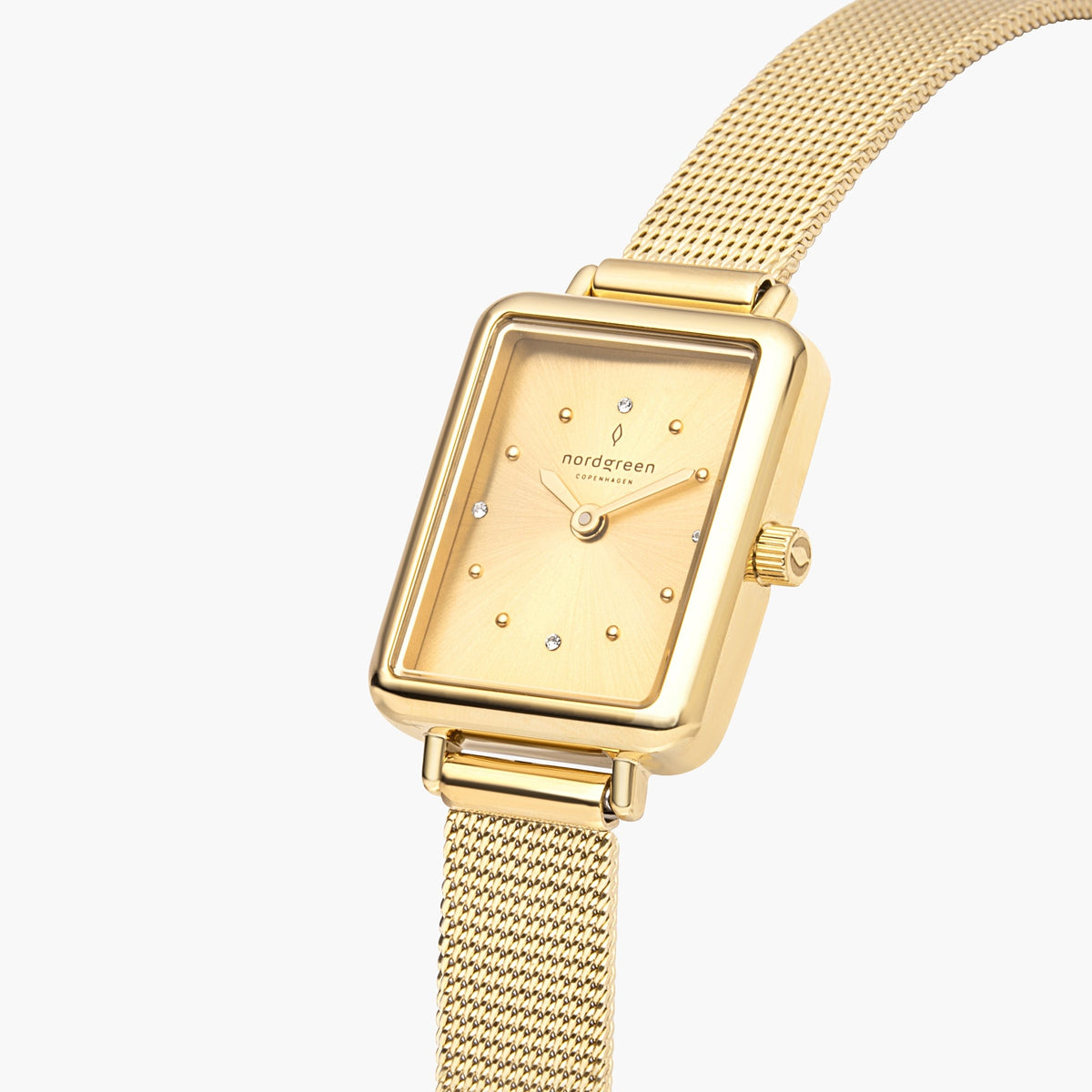 Angled close look at the gold dial with dot markers and small stones.