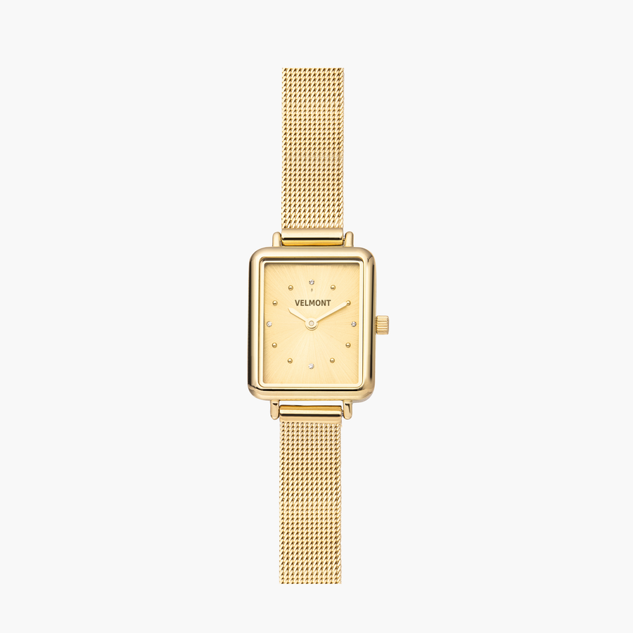 Petite rectangular watch in gold tone with a matching fine mesh strap, front view.