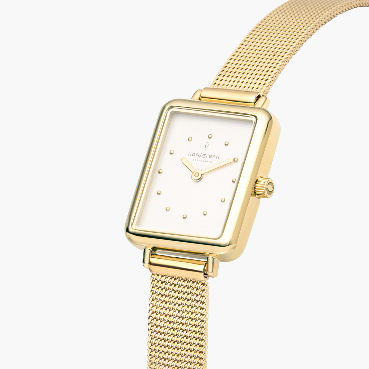 Angled close look at the white dial with gold-tone dot markers.