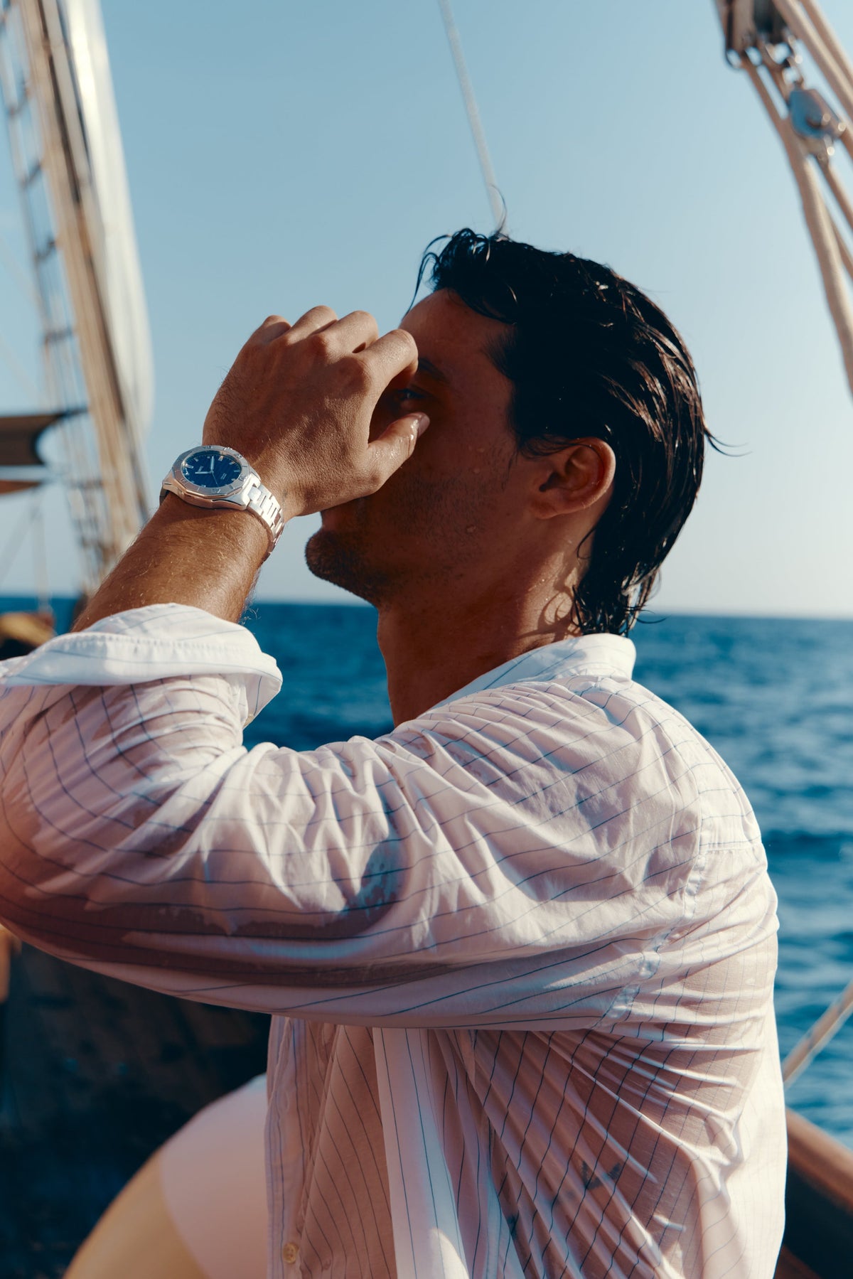Man in a white shirt on a boat wearing the watch