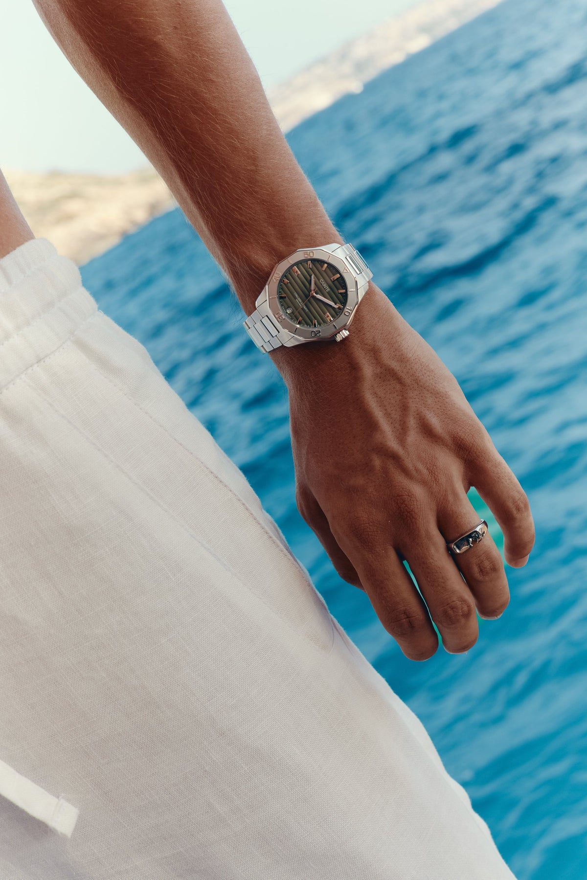 Green-dial automatic watch on the wrist, top view