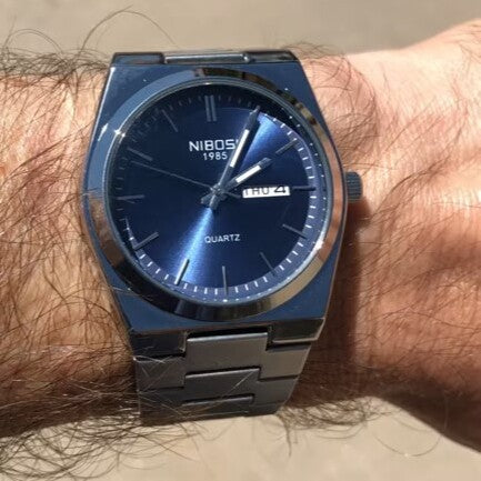 Blue dial watch on the wrist