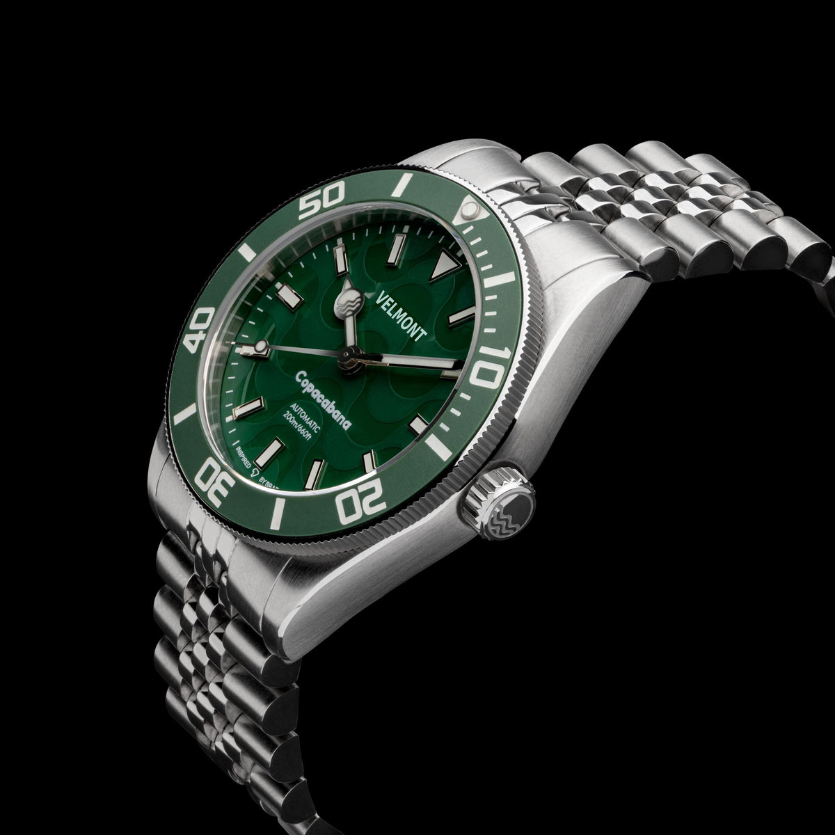 Green watch on bracelet at an angle on black