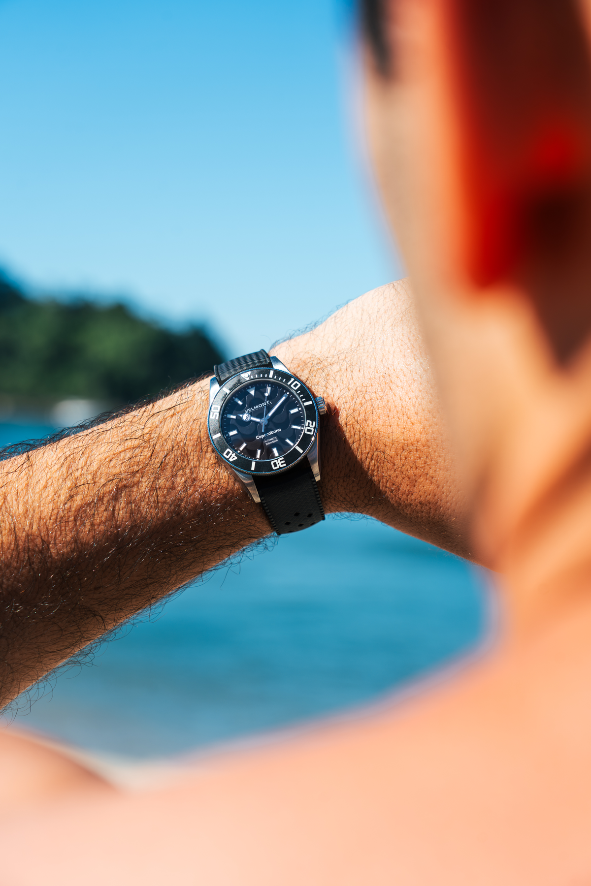 Watch on the wrist against the sky
