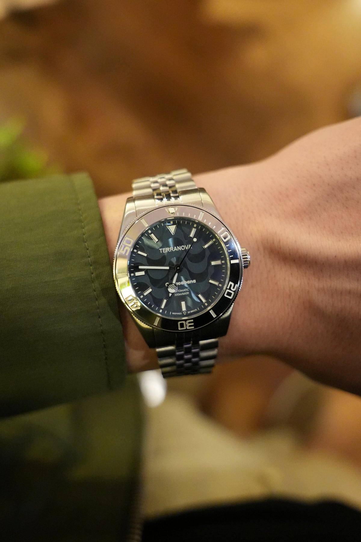 Blue dial watch on the wrist