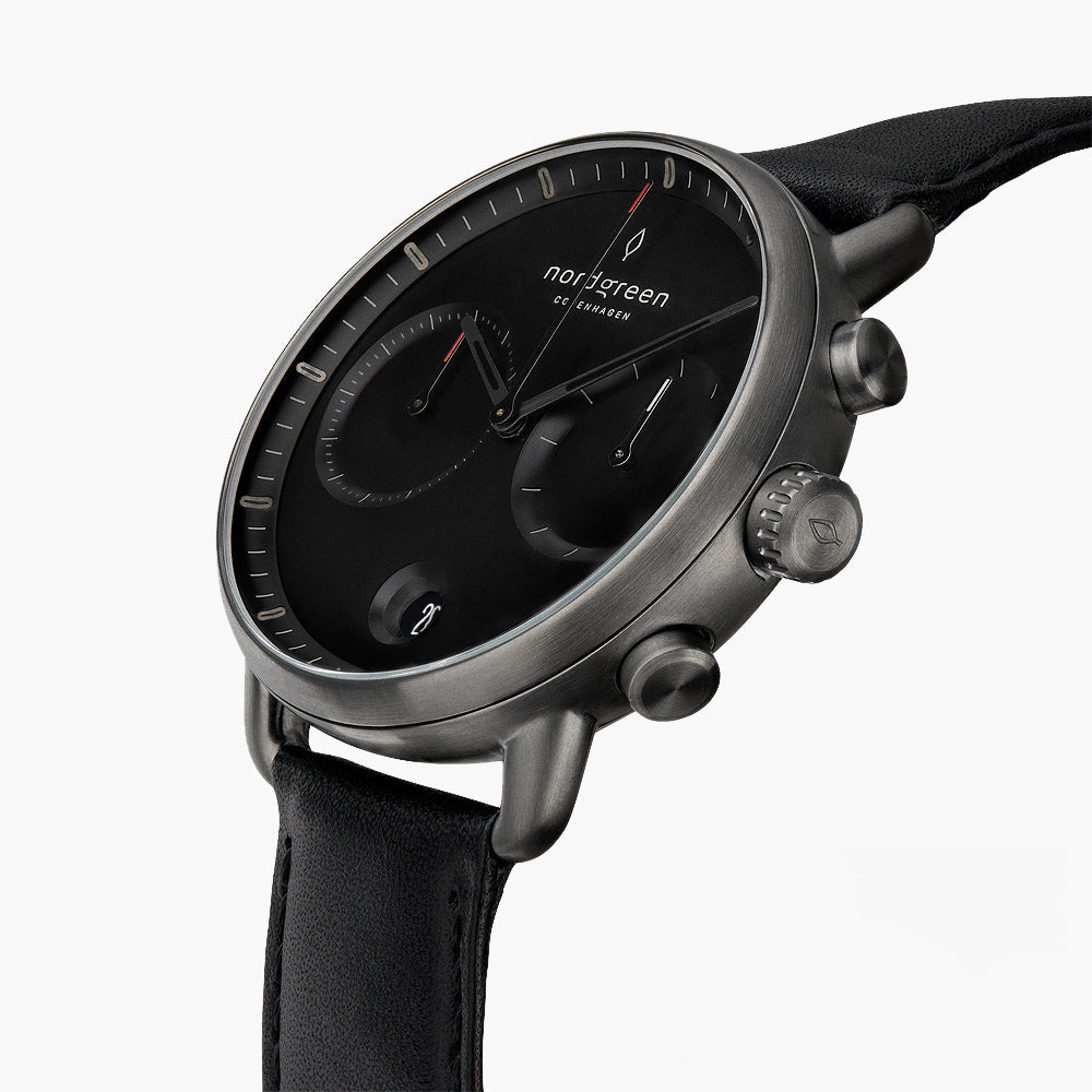 Angled view of the black dial, subdials and gunmetal pushers.