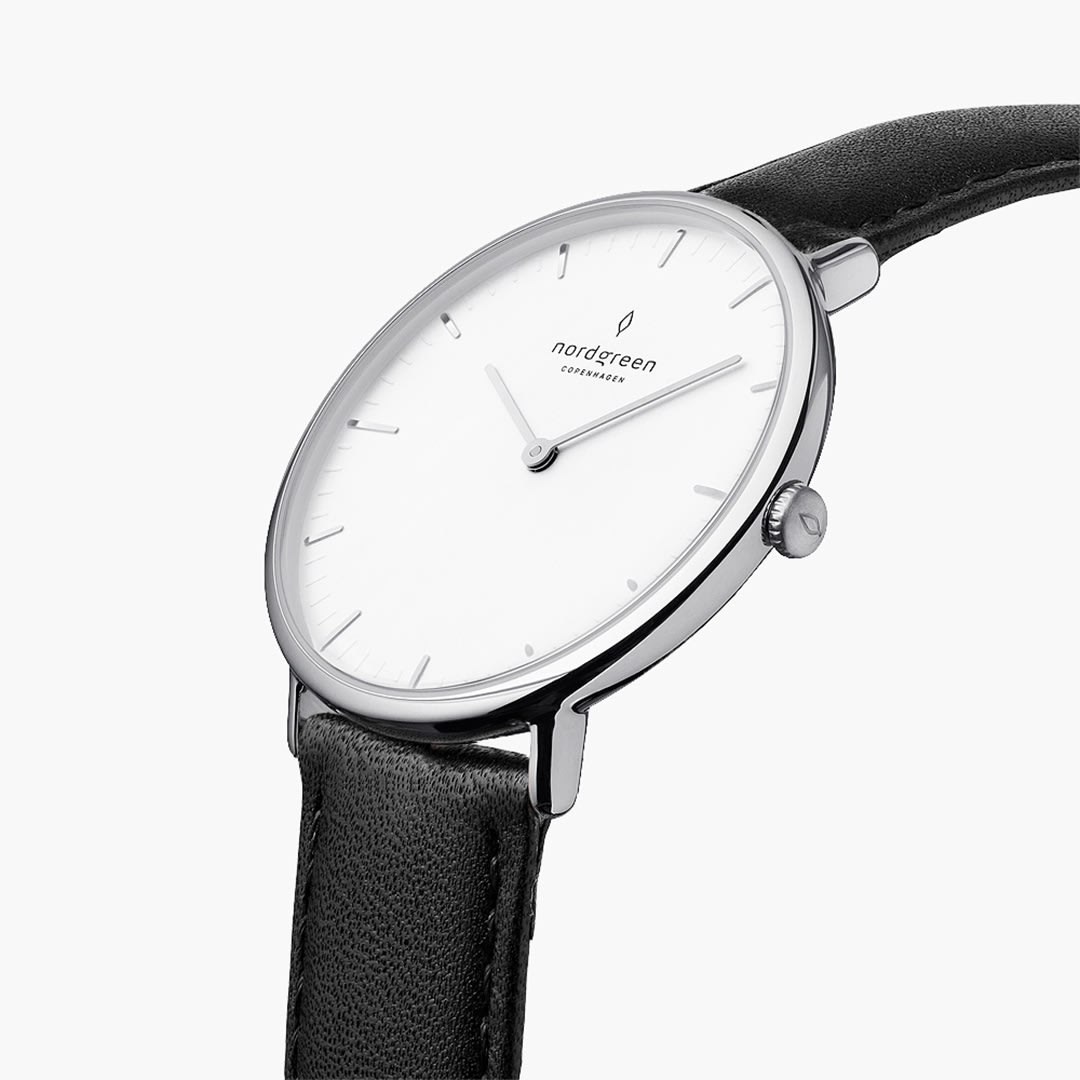Three-quarter angle of the silver-tone case showing the crown and white dial.