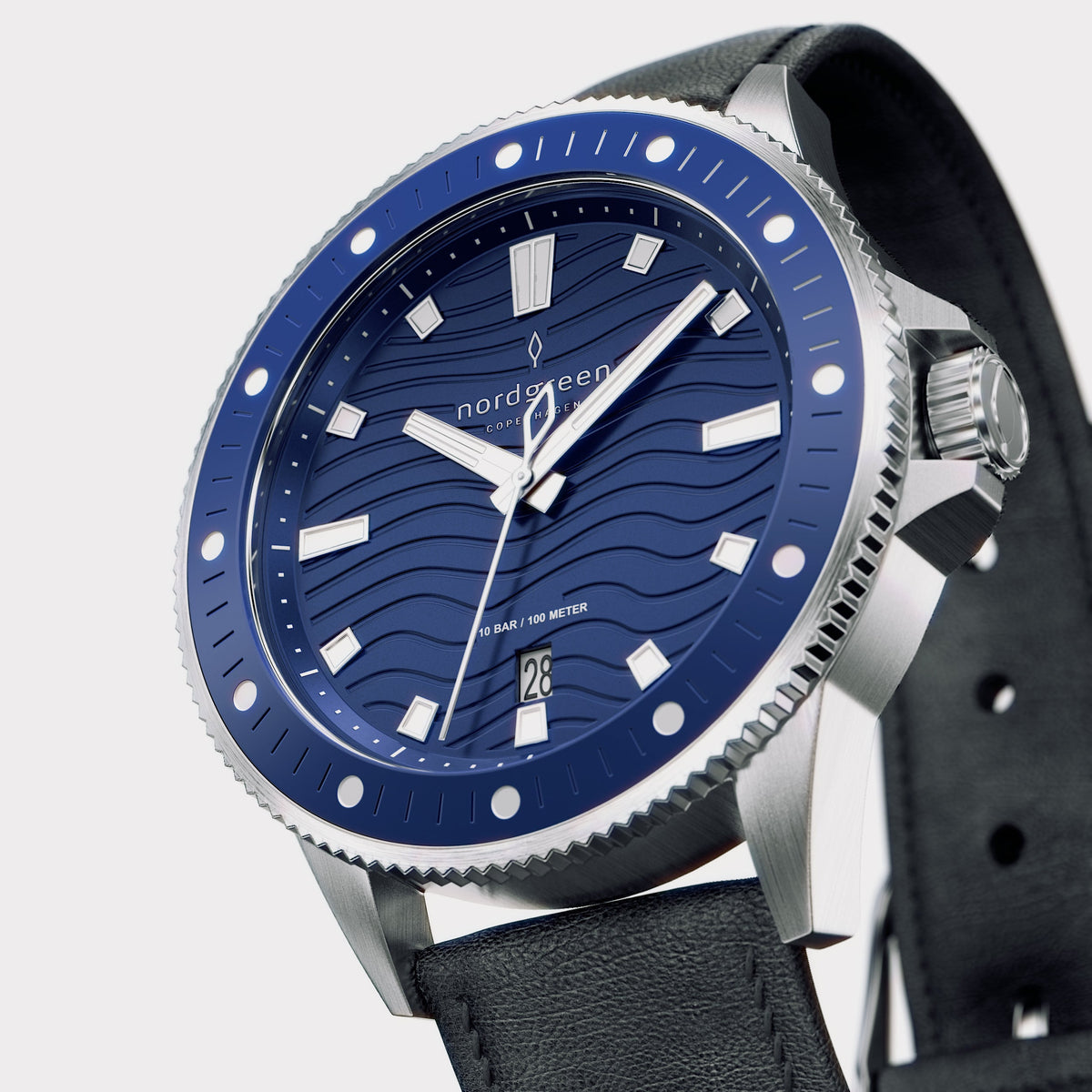 Three-quarter view showing the blue bezel with white dots and the silver-tone crown.