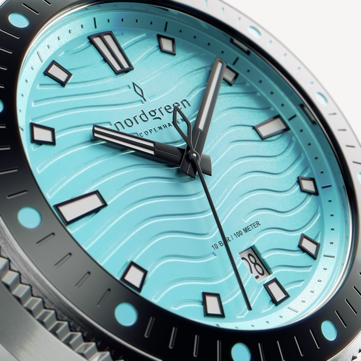 Close-up of the turquoise wave-textured dial with white-filled indices.