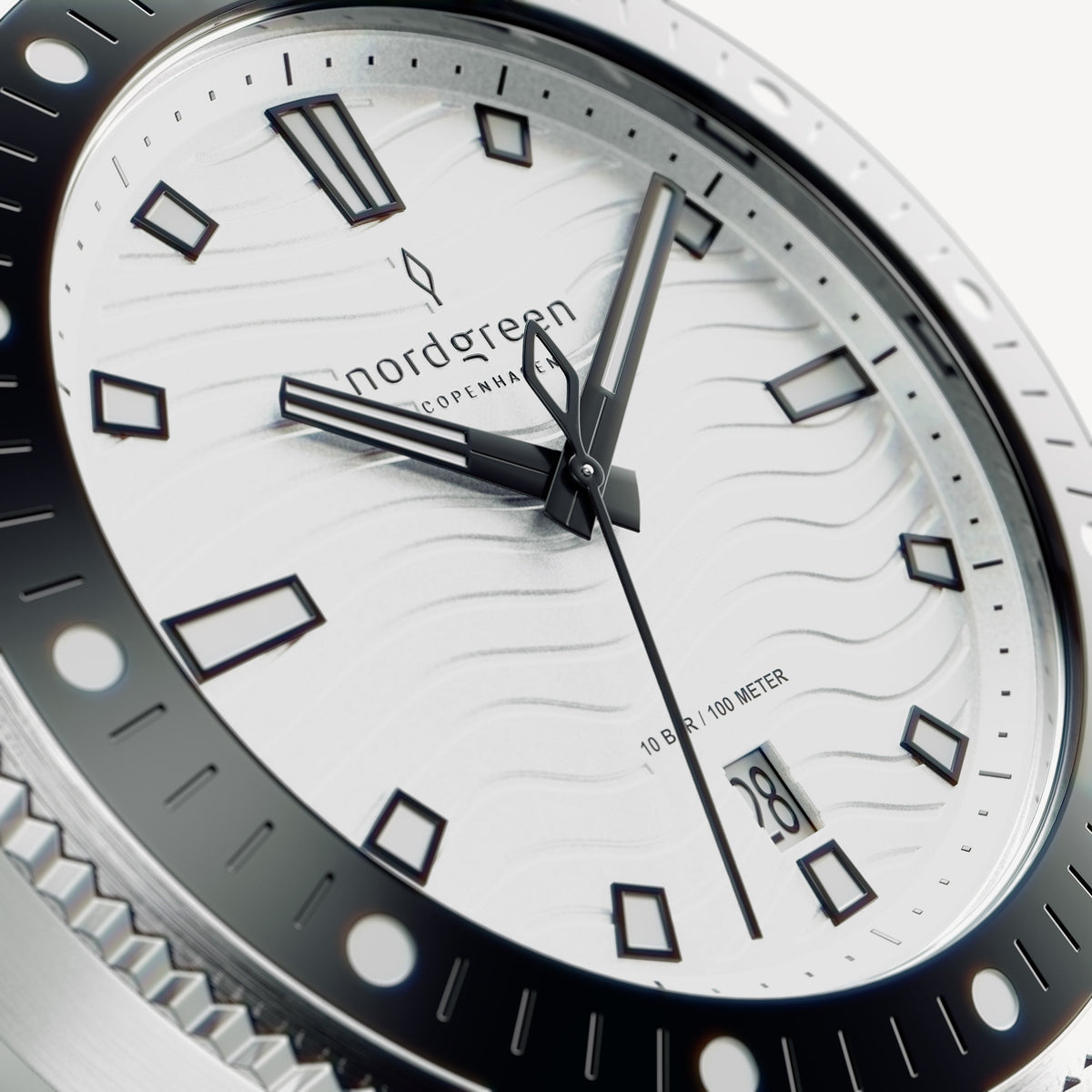 Close-up of the white wave dial with black-outlined indices and date window.