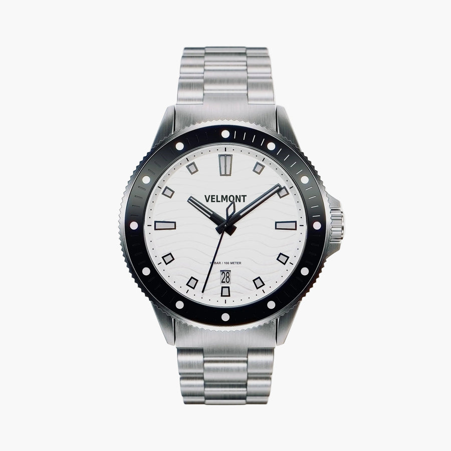Diver-style watch with a white wave dial, black bezel and silver-tone link bracelet.