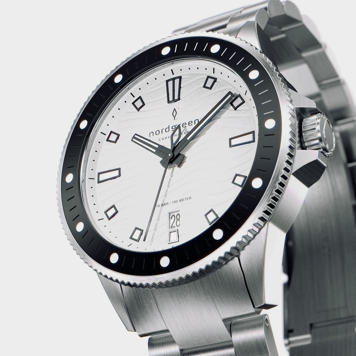 Three-quarter view of the white dial, black bezel and brushed bracelet.