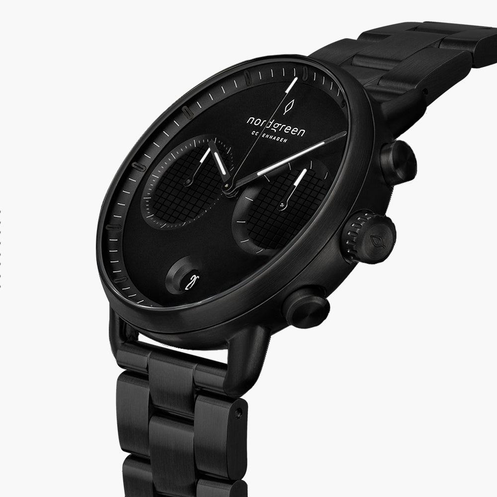 Angled view of the black dial, white-accented hands and black pushers.