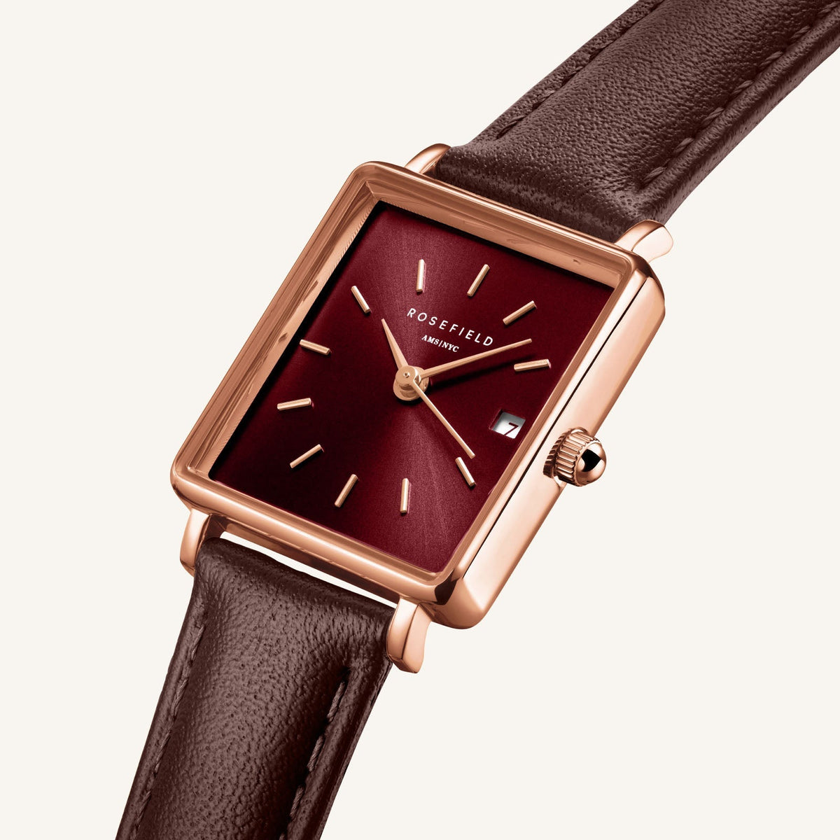 Close-up of the burgundy sunray dial and date window