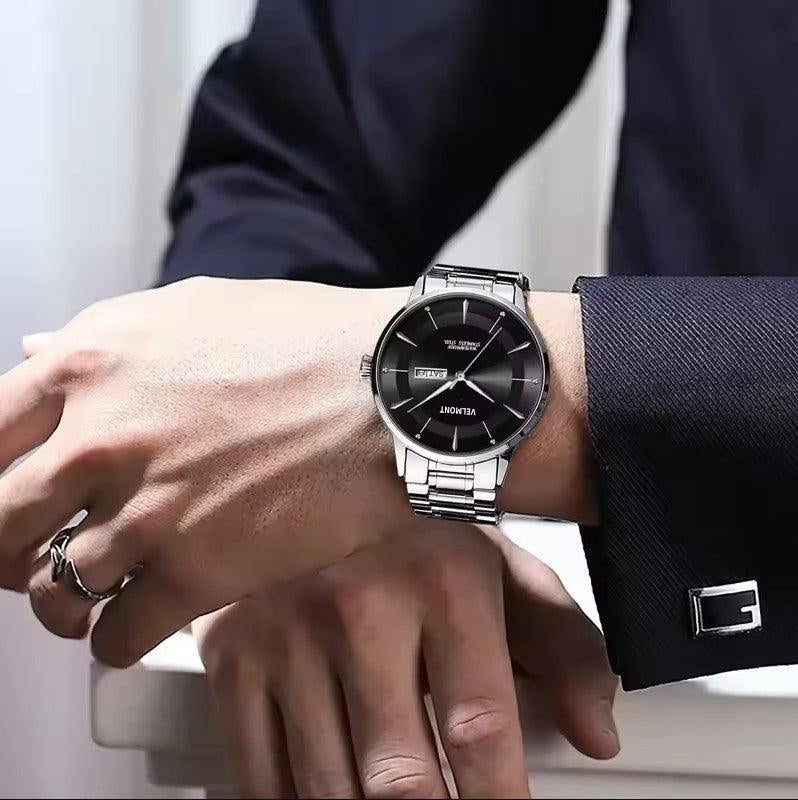 Steel watch worn with a dark suit