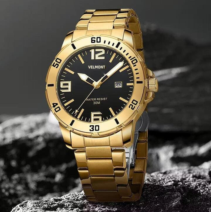 Gold-tone watch on a rock