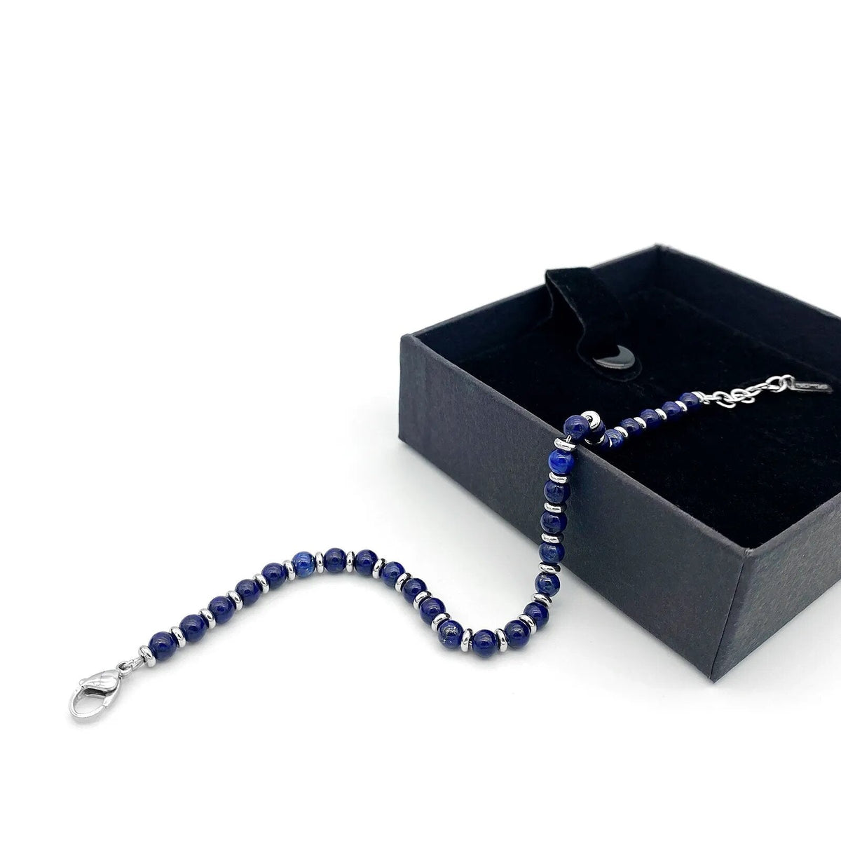 Beaded bracelet draped from a black gift box