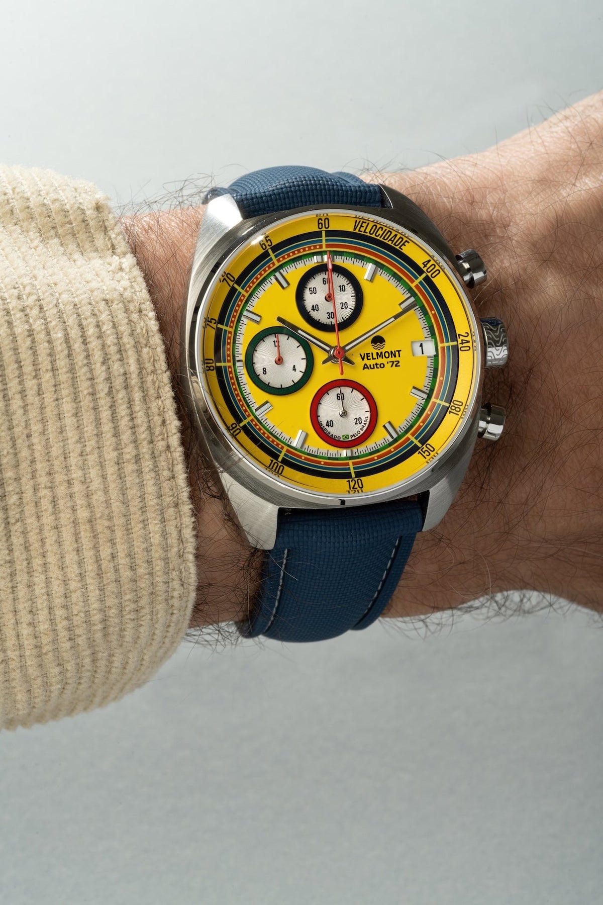 Yellow chronograph on the wrist with a blue strap