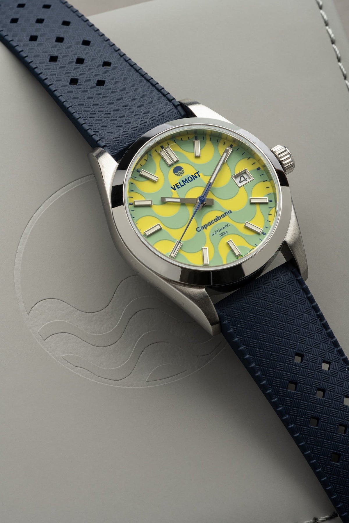 Wave dial watch on a blue strap at an angle