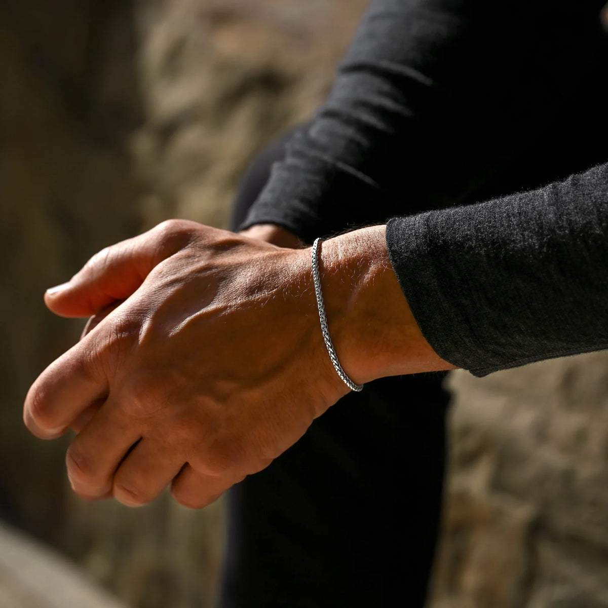 Wheat chain bracelet worn with hands clasped