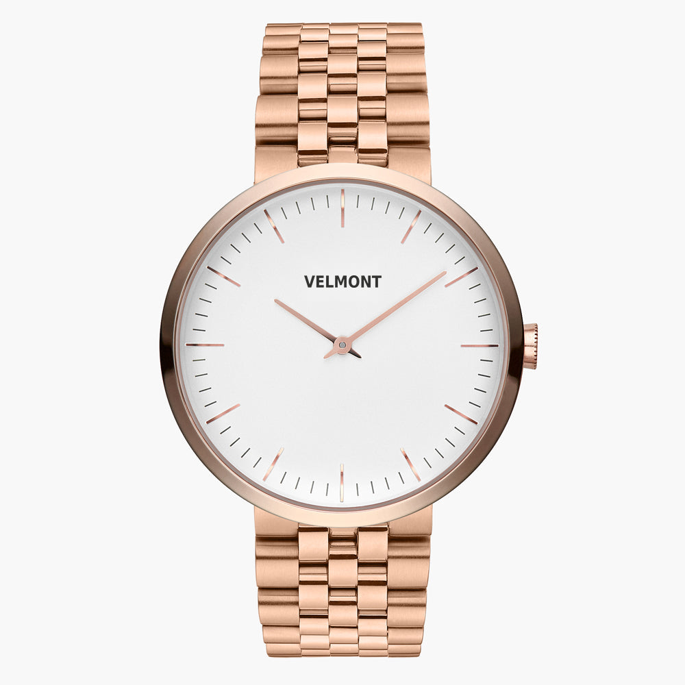 Minimalist watch with a white dial and rose gold-tone case on a matching link bracelet.