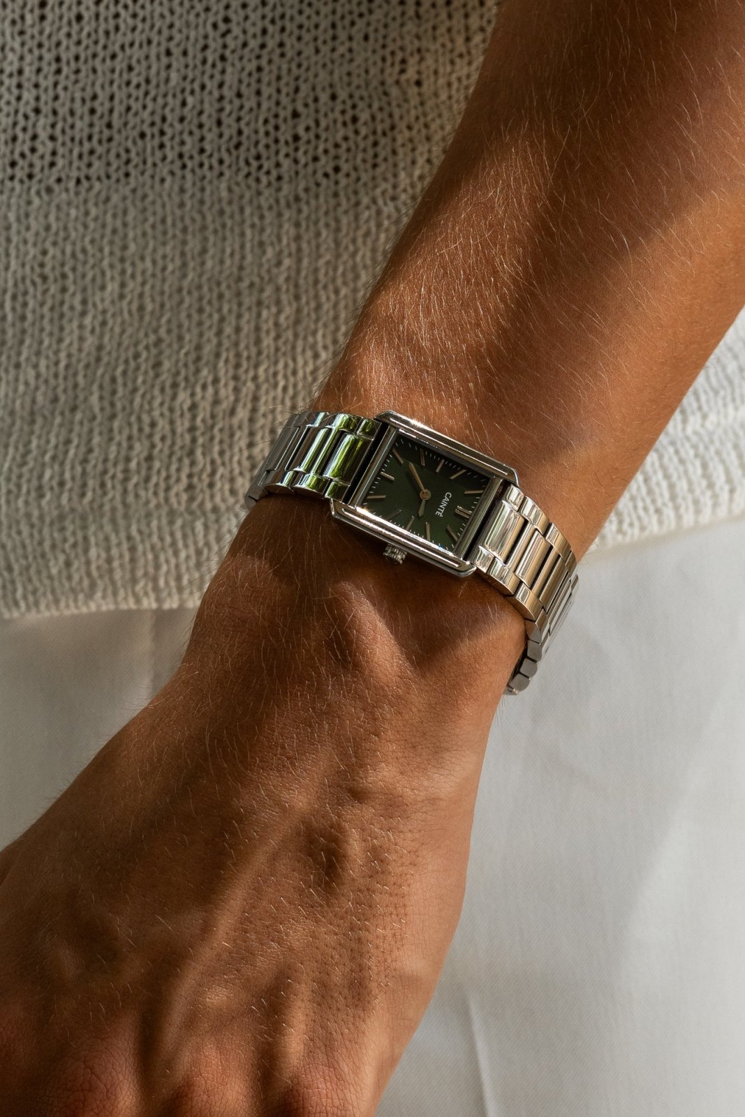 Close-up of the rectangular watch on the wrist