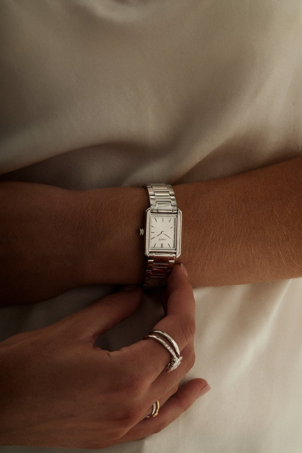 Woman in a white top with the stone-set watch on her wrist
