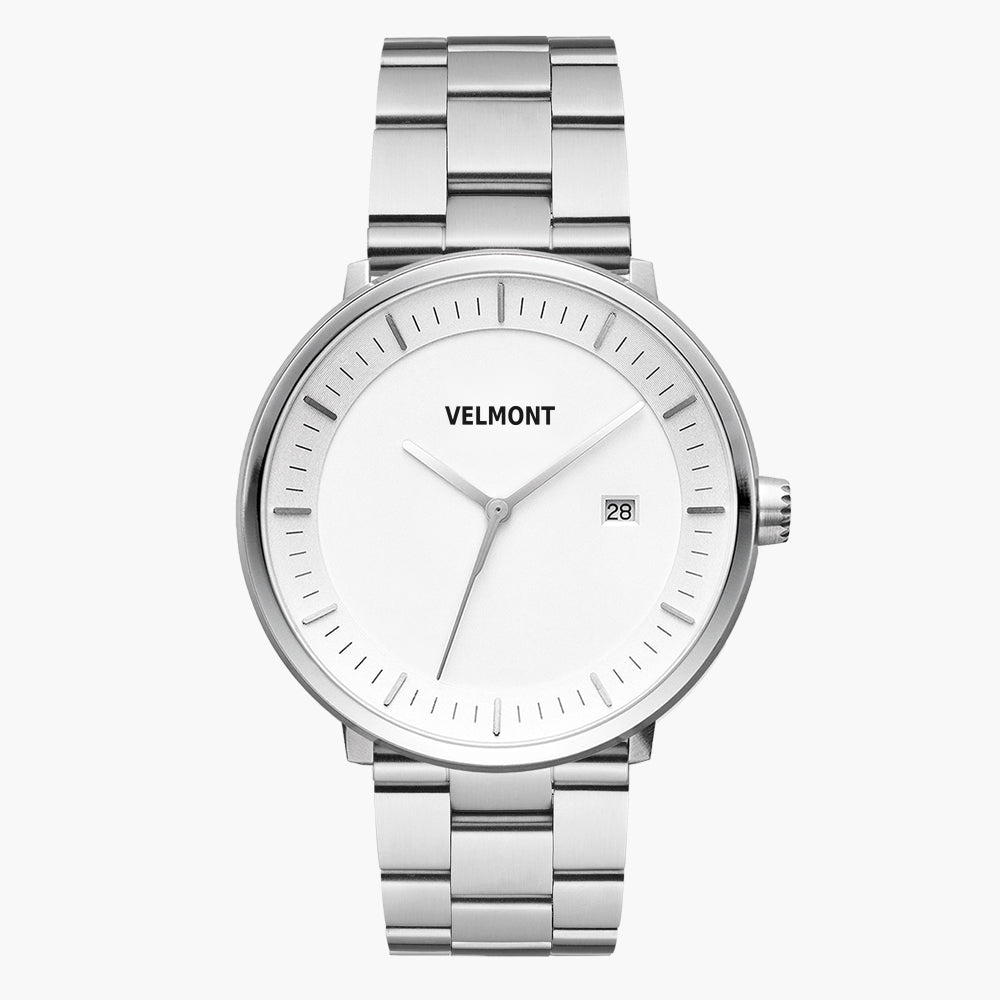 Silver-tone watch with a white dial and date window on a three-row bracelet.