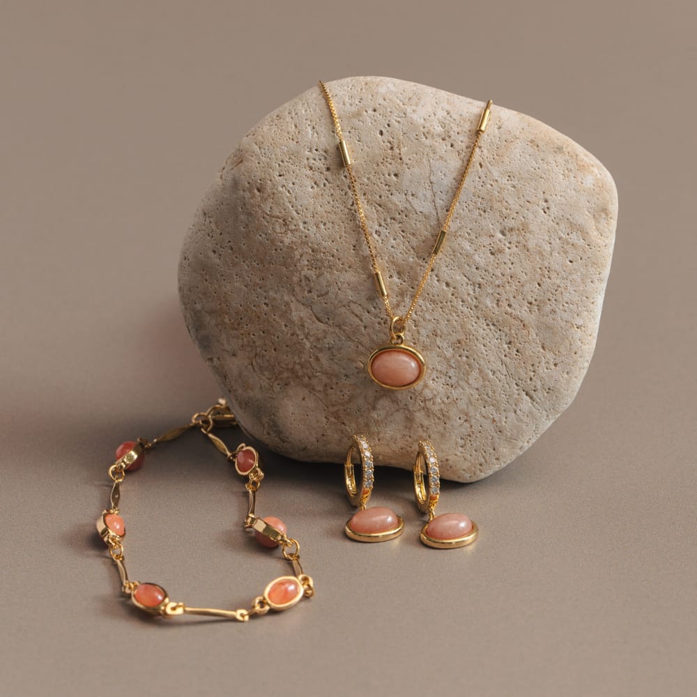 Pink stone bracelet shown with a matching necklace and earrings